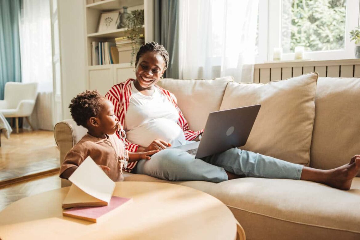 pregnant mother juggles work and childcare